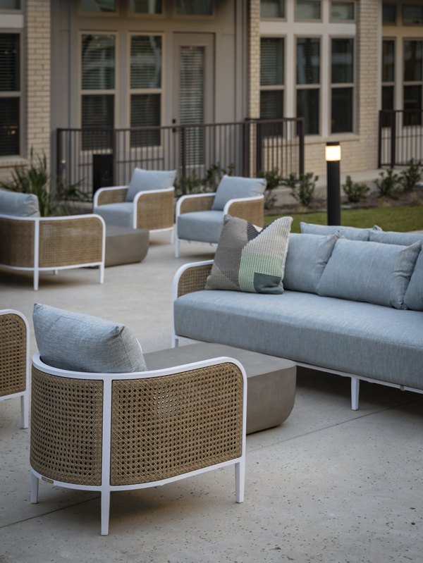 Courtyard featuring lush gardens and seating areas at The Ludlow Apartments, luxury living space for relaxation and socializing