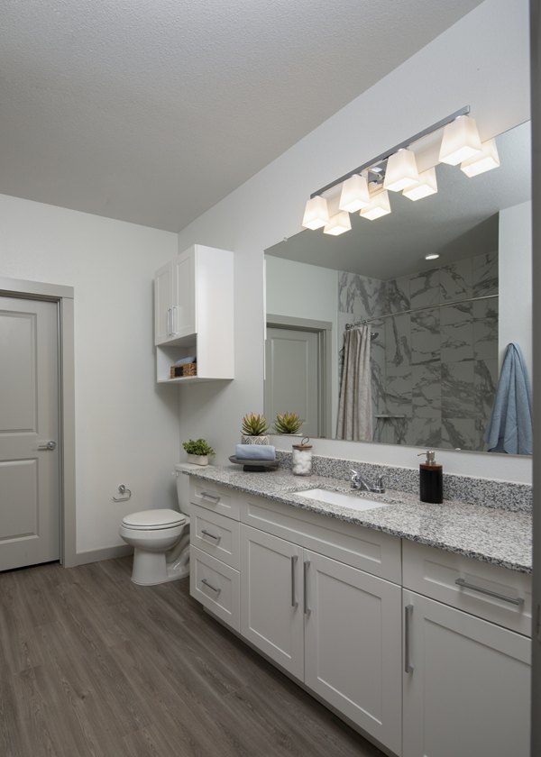 Bathroom with stylish fixtures and modern lighting at Prose North West Apartments