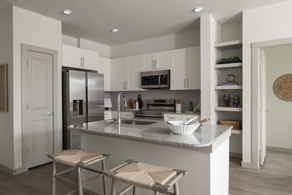 Modern kitchen with stainless steel appliances in Prose North West Apartments