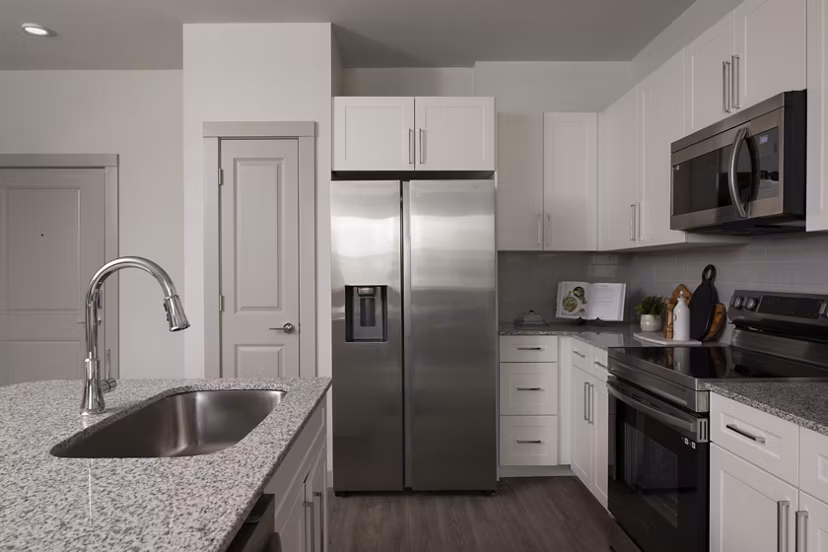 Kitchen featuring modern appliances and granite countertops in Prose North West Apartments luxury community