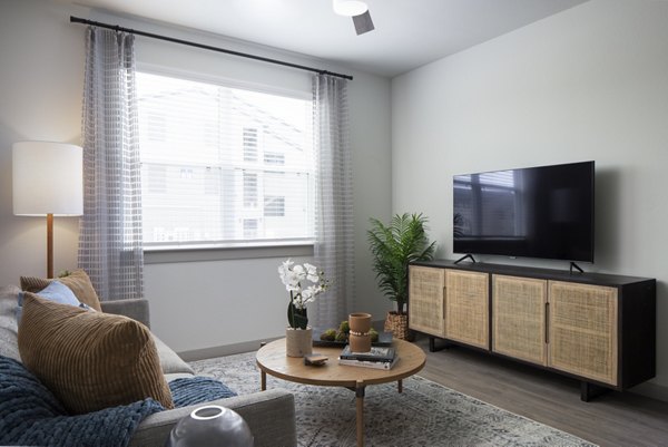 Spacious living room with modern decor in Prose North West Apartments