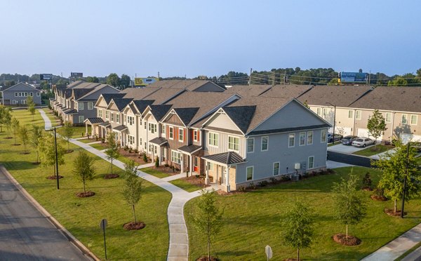 Tranquil Gardens Homes: Serene of modern residential building in lush landscaping