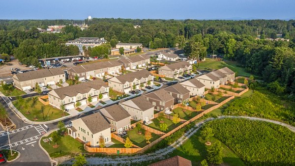 Tranquil Gardens Homes: Elegant building with lush landscaping in suburban setting