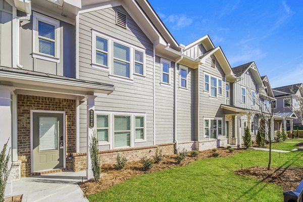 Tranquil Gardens Homes: Elegant building featuring lush landscaping in serene suburban setting