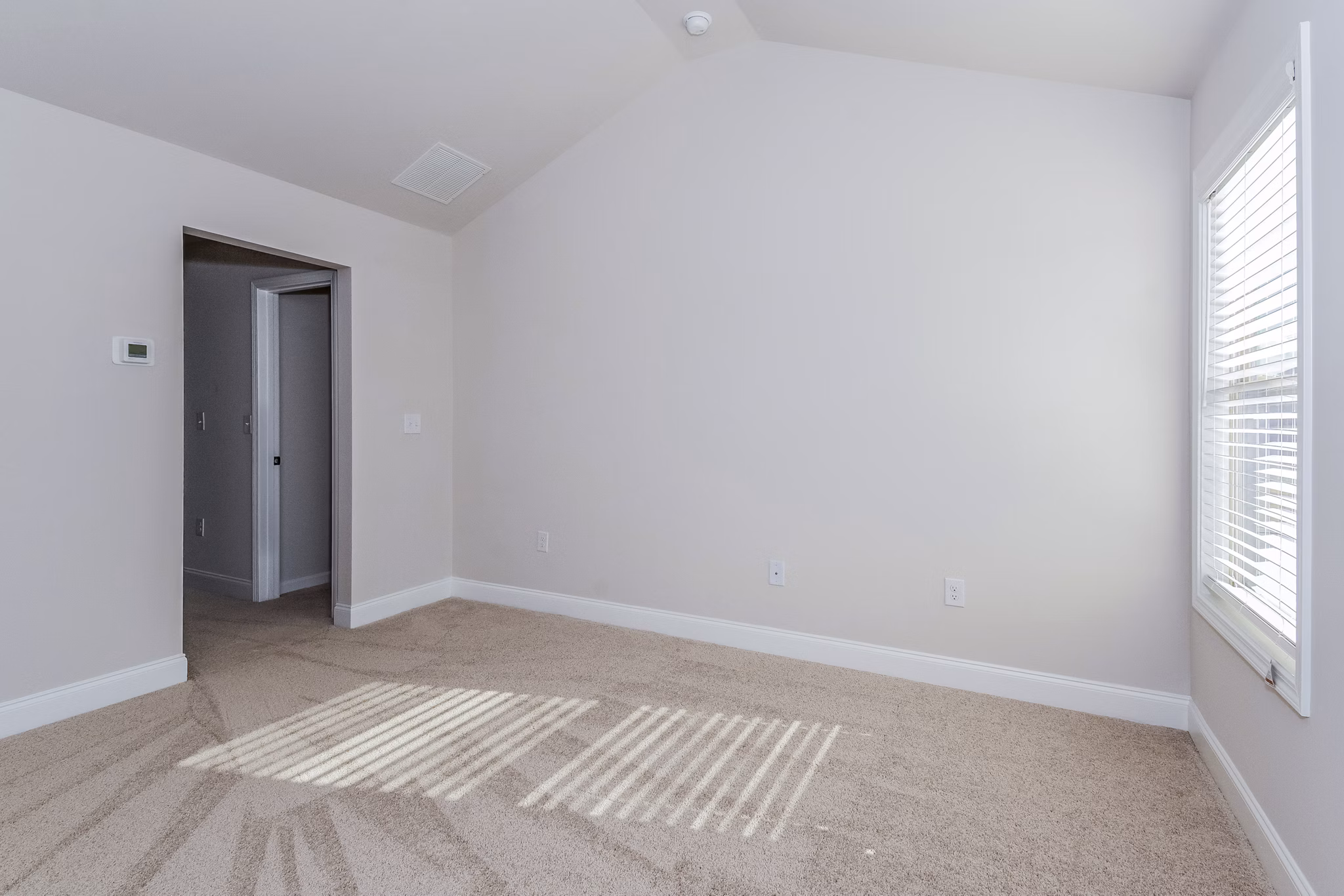 Tranquil Gardens Apartments: Cozy bedroom featuring plush bedding and natural light