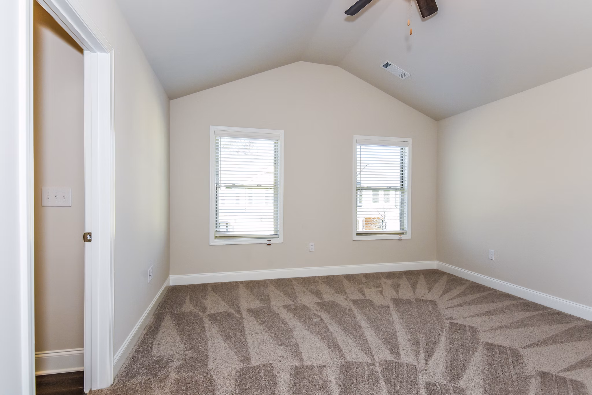 Cozy bedroom with plush bedding and natural light in Tranquil Gardens Apartments