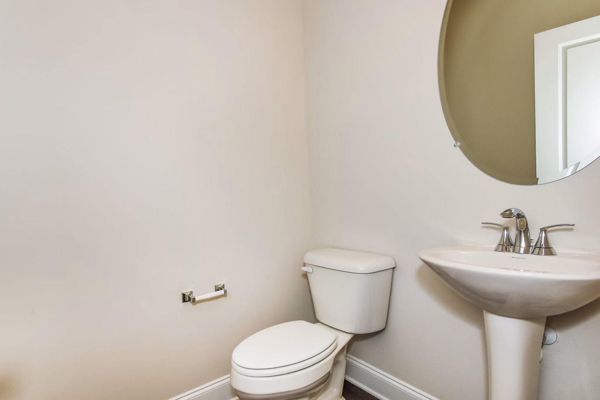 Bathroom featuring sleek fixtures and natural stone tiles in Tranquil Gardens Homes luxury apartment