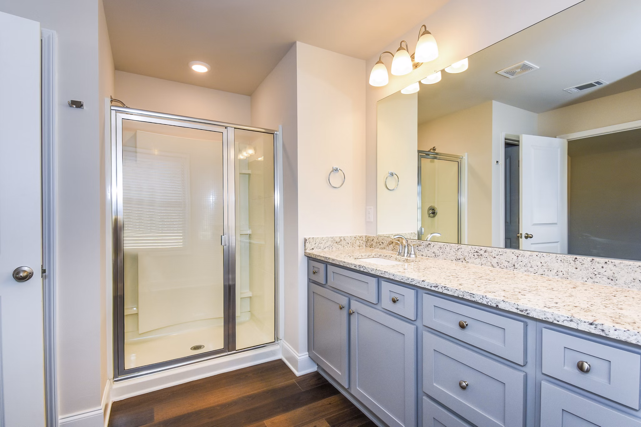 Bathroom with elegant fixtures and marble countertops at Tranquil Gardens Homes luxury apartments