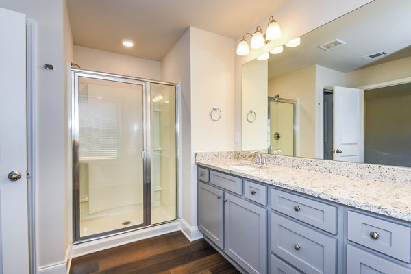 Bathroom with elegant fixtures and marble countertops at Tranquil Gardens Homes luxury apartments