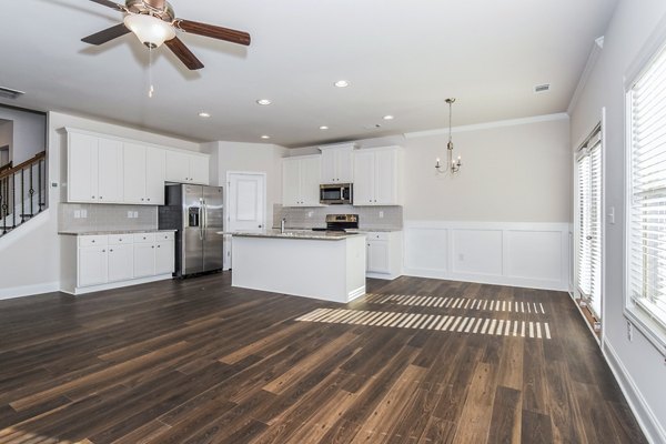 Dining area with elegant table setting and pendant lighting in Tranquil Gardens Apartments