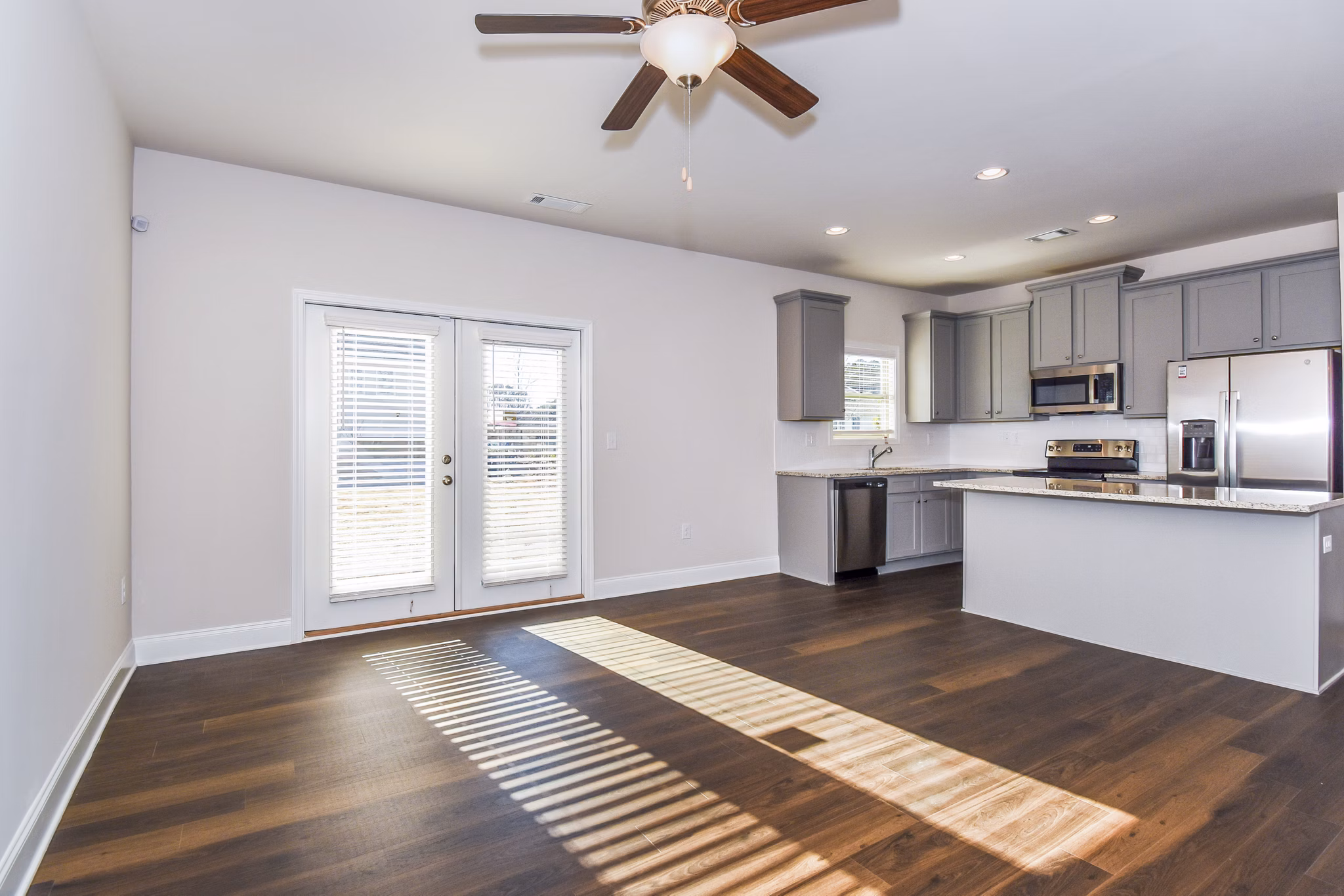 Dining room with elegant glass table and modern lighting at Tranquil Gardens Apartments