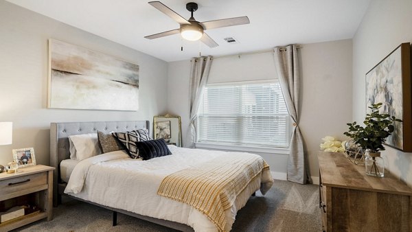 Cozy bedroom with stylish decor at Outlook Gwinnett Apartments