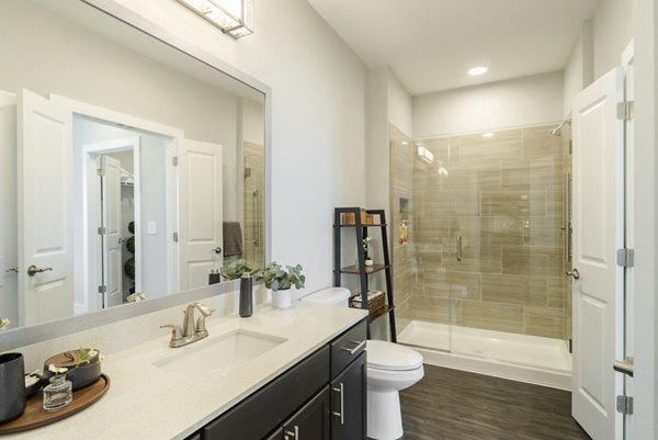 Bathroom featuring modern fixtures and sleek tile design at Outlook Gwinnett Apartments, a luxury property by Greystar