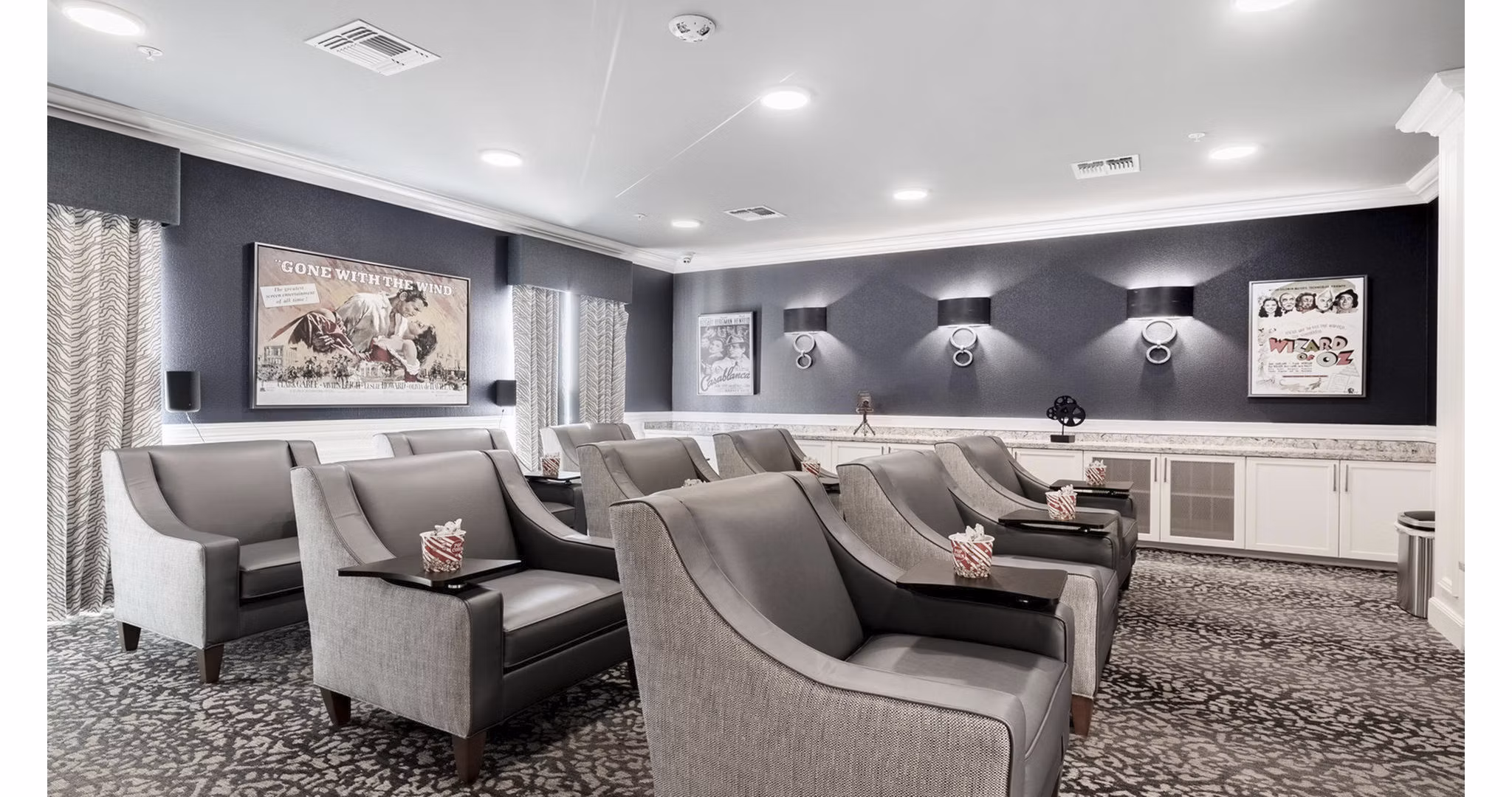 Theater with plush seating and large screen at Outlook Gwinnett Apartments offering cinematic experience for residents