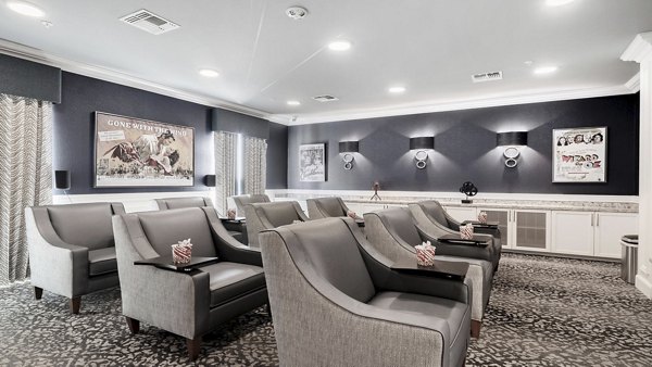 Theater with plush seating and large screen at Outlook Gwinnett Apartments offering cinematic experience for residents