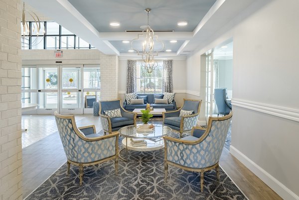 Modern clubhouse with stylish seating and game area at Outlook Gwinnett Apartments, offering luxury amenities for residents