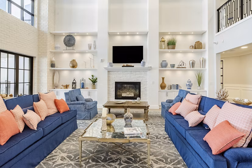 Clubhouse with recreational seating and large-screen TV at Outlook Gwinnett Apartments, perfect for social gatherings and relaxation