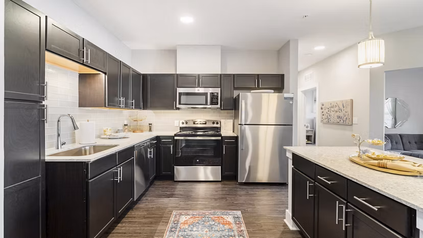 Modern kitchen with stainless steel appliances at Outlook Gwinnett Apartments, offering luxury living spaces for residents