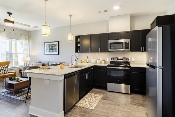 Kitchen featuring modern stainless steel appliances at Outlook Gwinnett Apartments