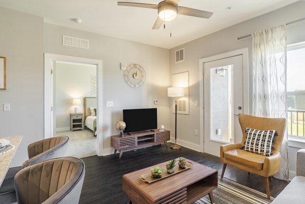 Cozy living room with modern furnishings and ample natural light at Outlook Gwinnett Apartments