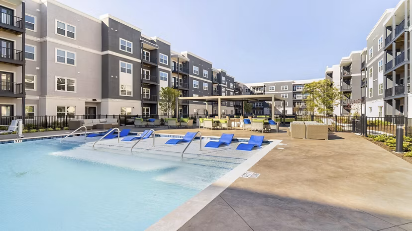 Resort-style pool with sun loungers at Outlook Gwinnett Apartments