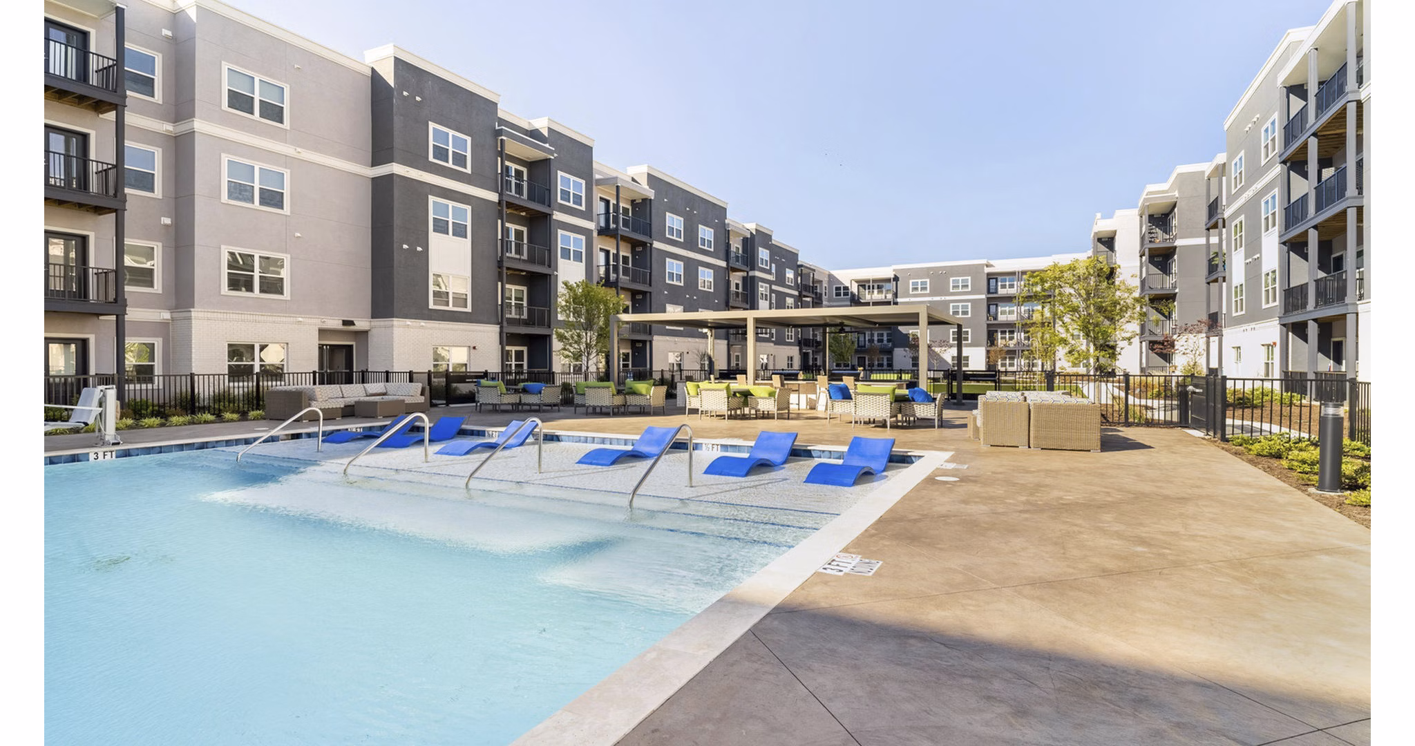 Resort-style pool with sun loungers at Outlook Gwinnett Apartments