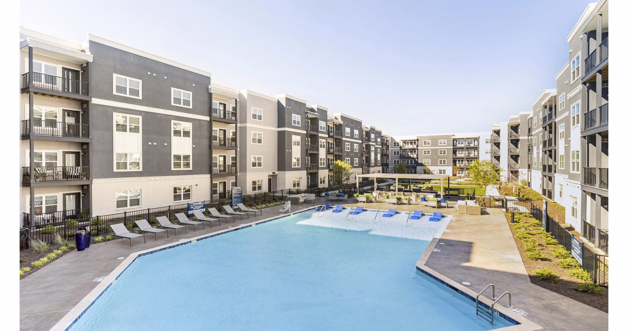 Resort-style pool with lounge chairs at Outlook Gwinnett Apartments
