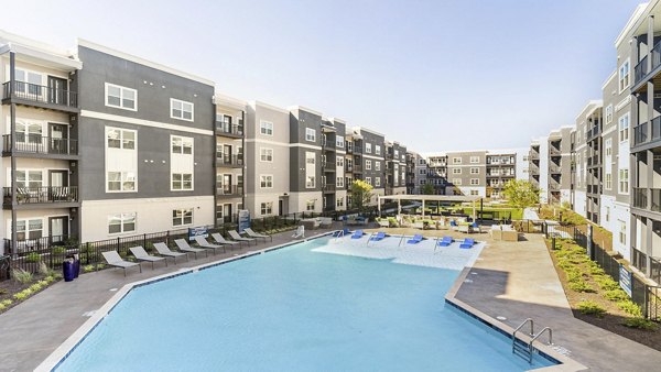 Resort-style pool with lounge chairs at Outlook Gwinnett Apartments