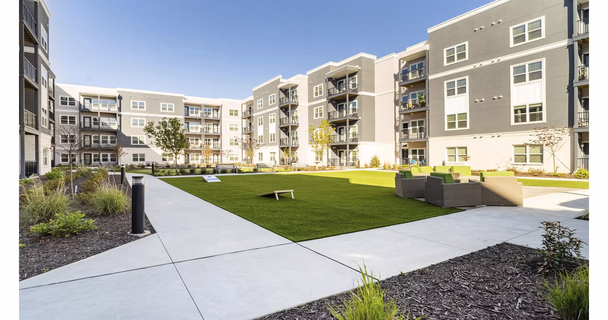 Beautifully landscaped courtyard with seating areas at Outlook Gwinnett Apartments