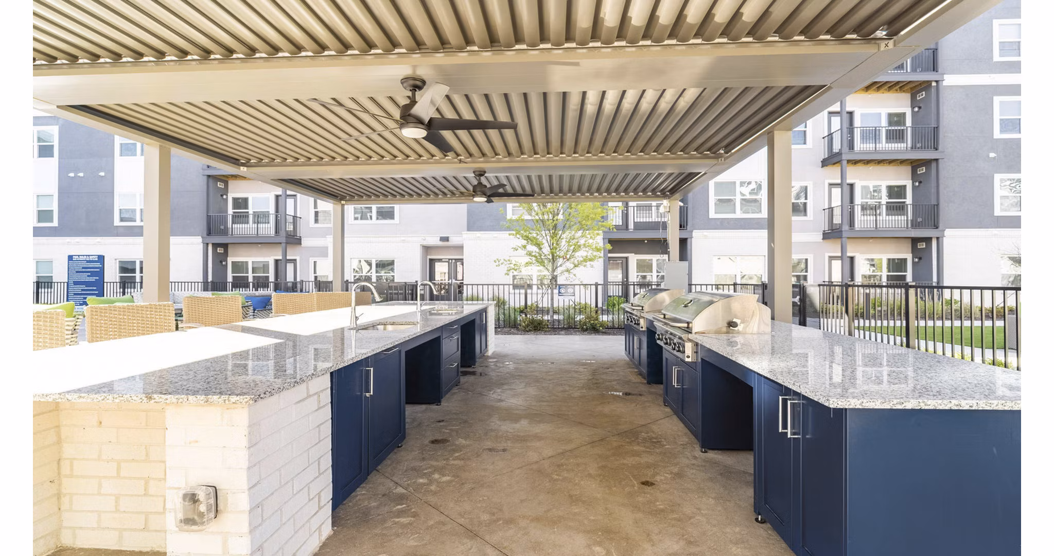 Outdoor BBQ grill area with modern seating at Outlook Gwinnett Apartments, perfect for community gatherings and leisure in a luxury setting