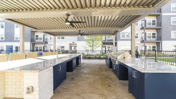 Outdoor BBQ grill area with modern seating at Outlook Gwinnett Apartments, perfect for community gatherings and leisure in a luxury setting