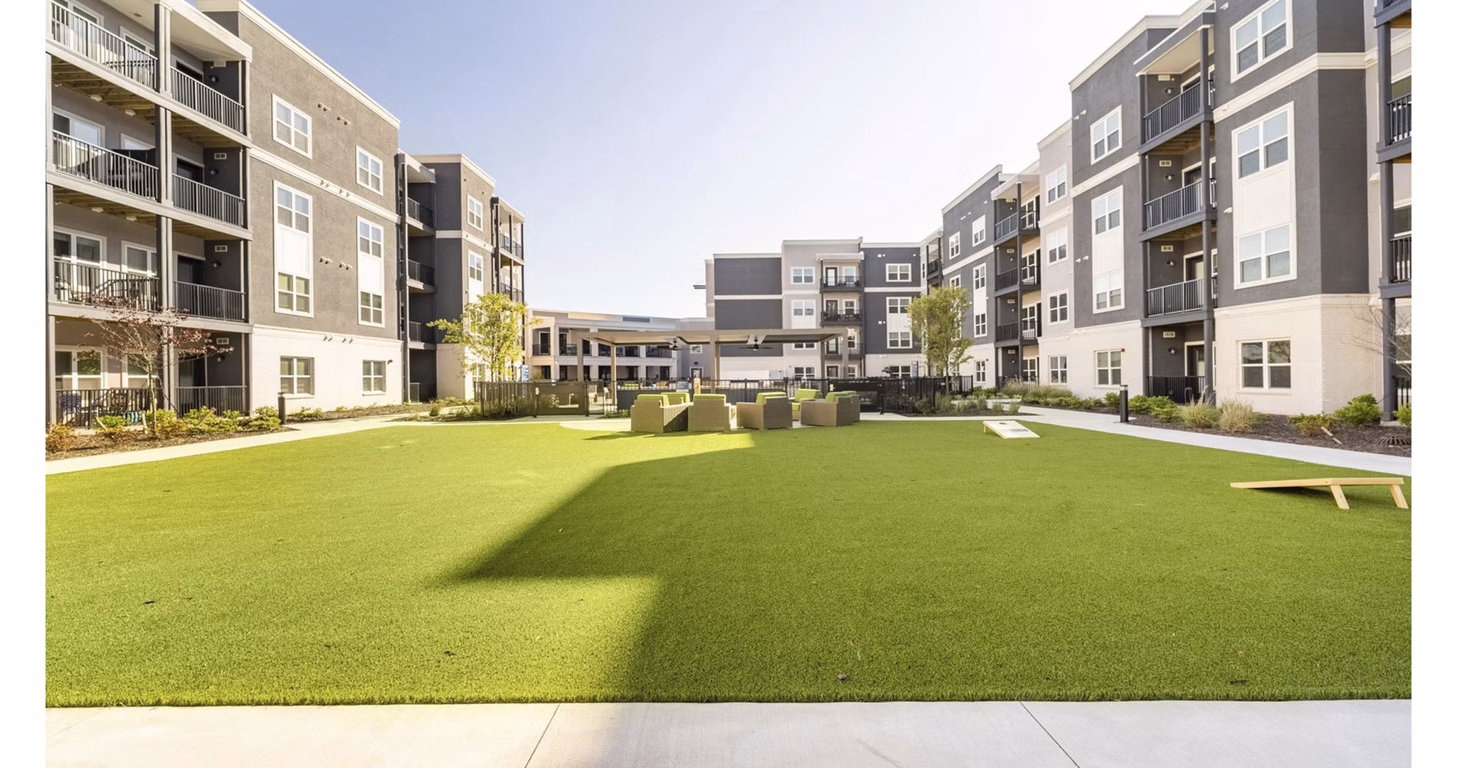 Courtyard with landscaped gardens at Outlook Gwinnett Apartments, featuring ample seating areas and walking paths