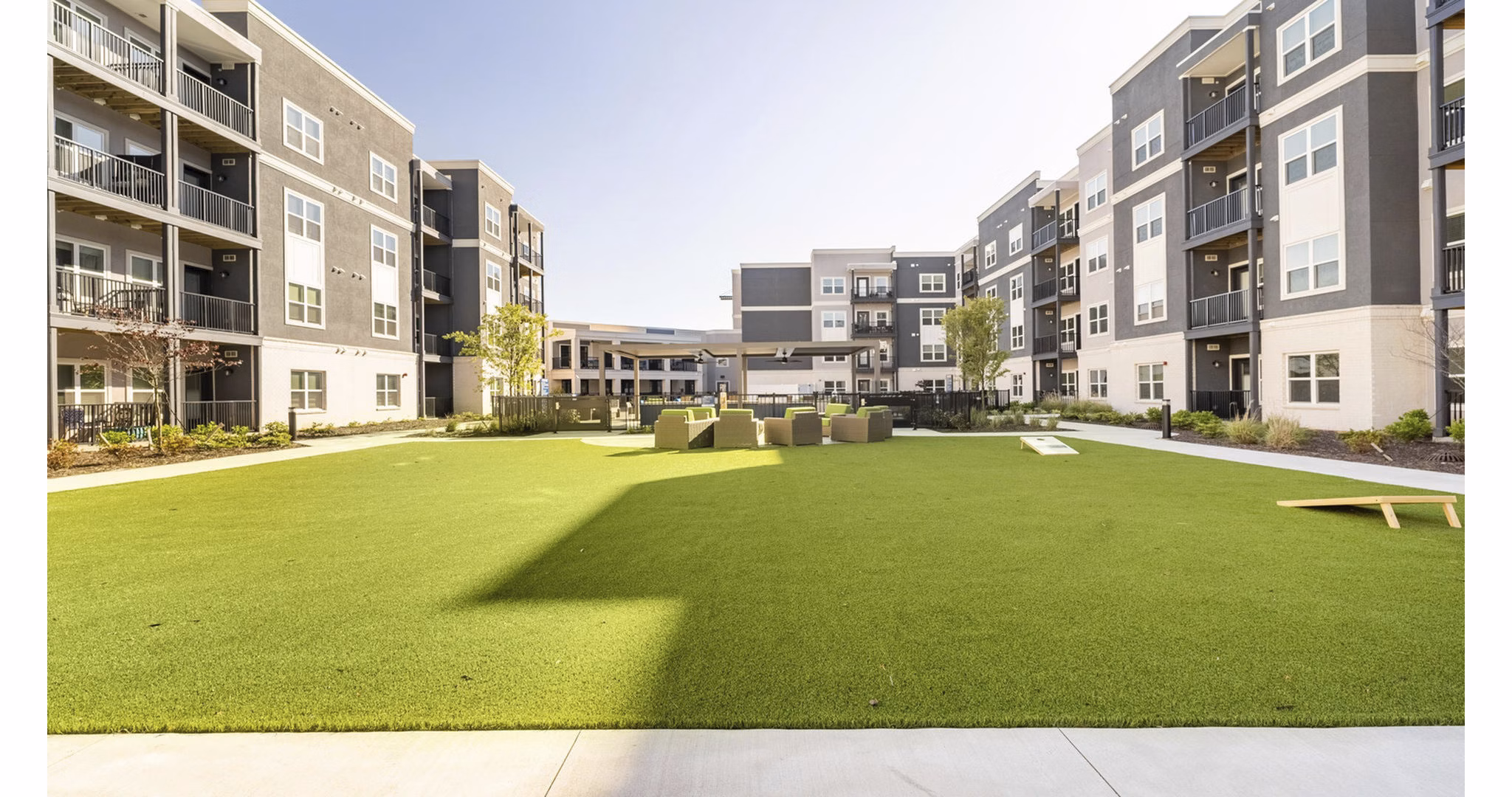 Courtyard with landscaped gardens at Outlook Gwinnett Apartments, featuring ample seating areas and walking paths
