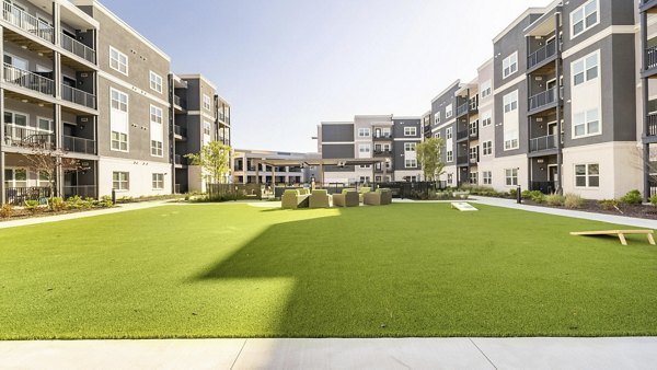 Courtyard with landscaped gardens at Outlook Gwinnett Apartments, featuring ample seating areas and walking paths