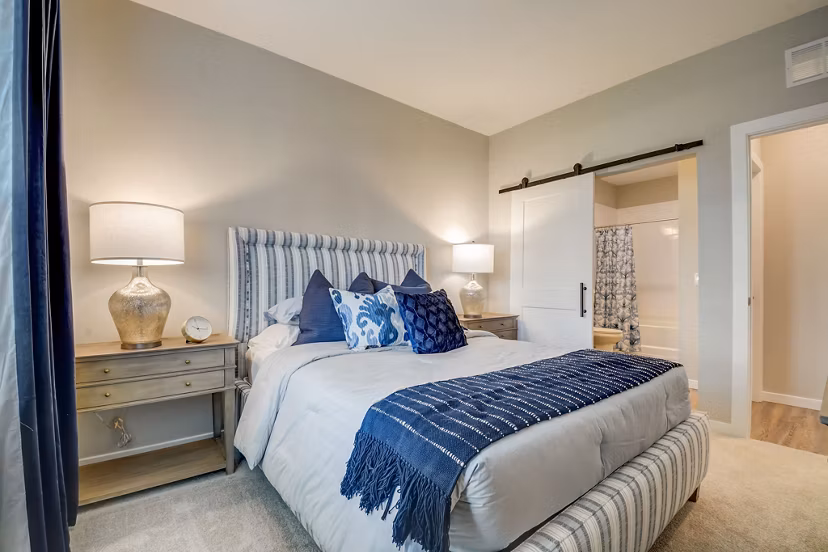 Bedroom featuring modern decor and ample natural light at Outlook Hamilton Apartments