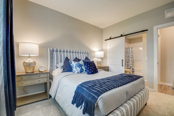 Bedroom featuring modern decor and ample natural light at Outlook Hamilton Apartments