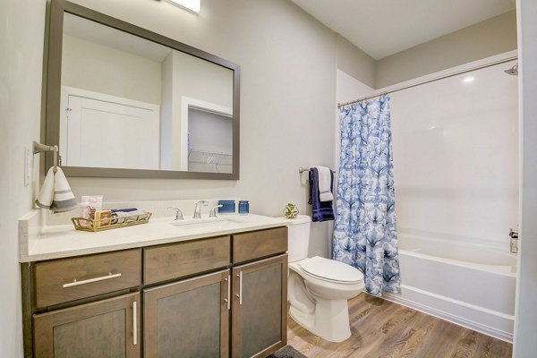 Modern bathroom featuring sleek fixtures and marble countertops in Outlook Hamilton Apartments