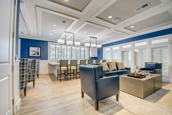 Modern clubhouse featuring expansive seating and large-screen TV at Outlook Hamilton Apartments