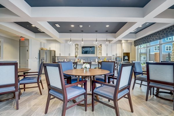 Clubhouse featuring modern dÃ©cor and plush seating at Outlook Hamilton Apartments for communal gatherings and relaxation