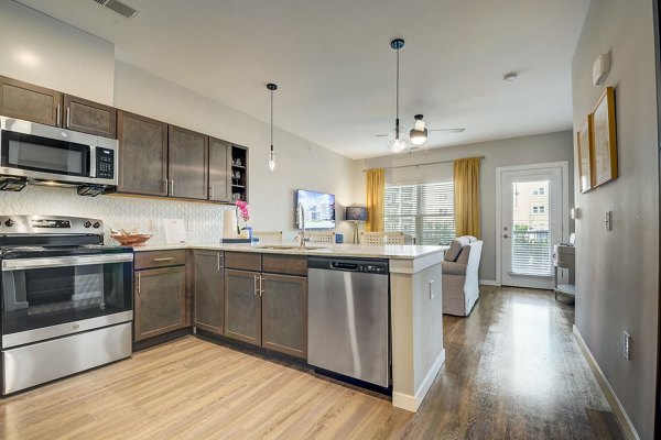 Modern kitchen with stainless steel appliances at Outlook Hamilton Apartments