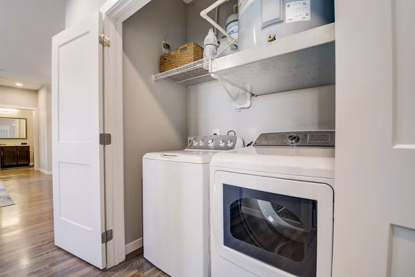 Laundry room with modern washers and dryers at Outlook Hamilton Apartments
