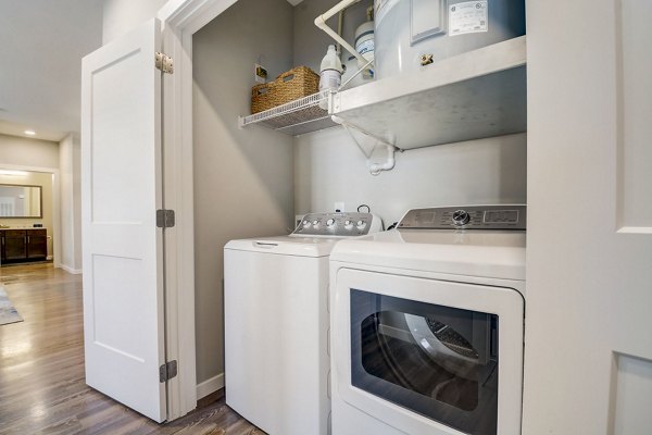 Laundry room with modern washers and dryers at Outlook Hamilton Apartments