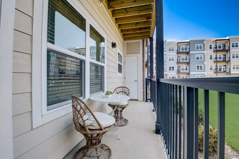 Outdoor patio with modern furniture at Outlook Hamilton Apartments offering scenic views
