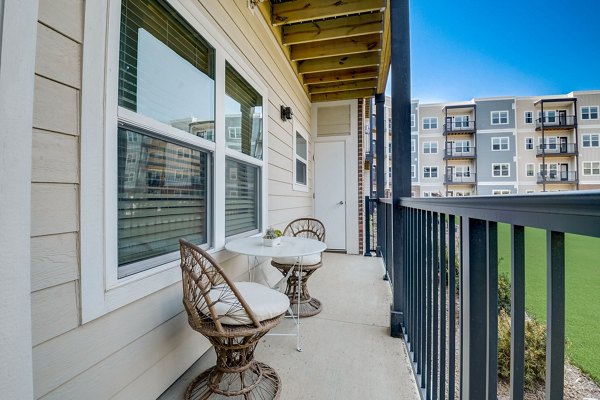 Outdoor patio with modern furniture at Outlook Hamilton Apartments offering scenic views