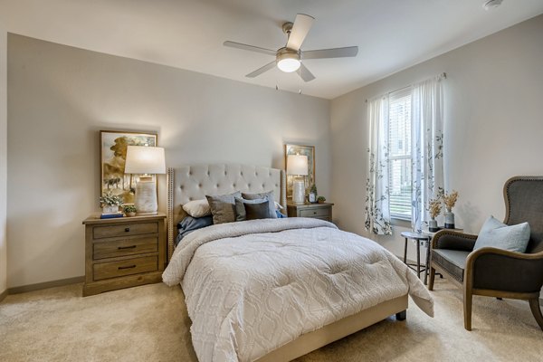 Cozy bedroom with modern decor at Alders Magnolia Apartments, a Greystar luxury property