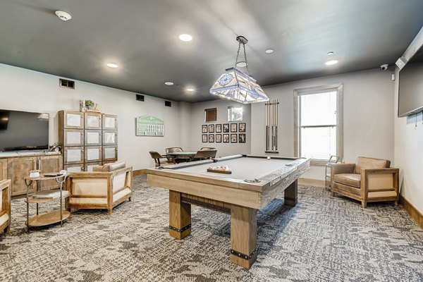 Game room with billiards and seating area at Alders Magnolia Apartments