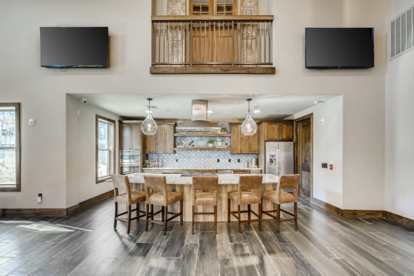 Alders Magnolia Apartments: Modern clubhouse equipped with elegant seating and entertainment features in Houston luxury community
