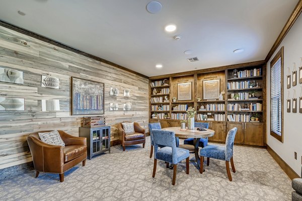 Inviting clubhouse featuring modern seating and a fireplace at Alders Magnolia Apartments