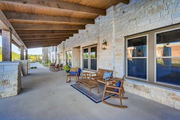 Stylish outdoor patio with modern seating at Alders Magnolia Apartments, perfect for relaxation and social gatherings