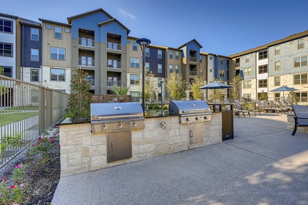 Outdoor grilling station with modern grills at Alders Magnolia Apartments, perfect for BBQ gatherings and al fresco dining experiences